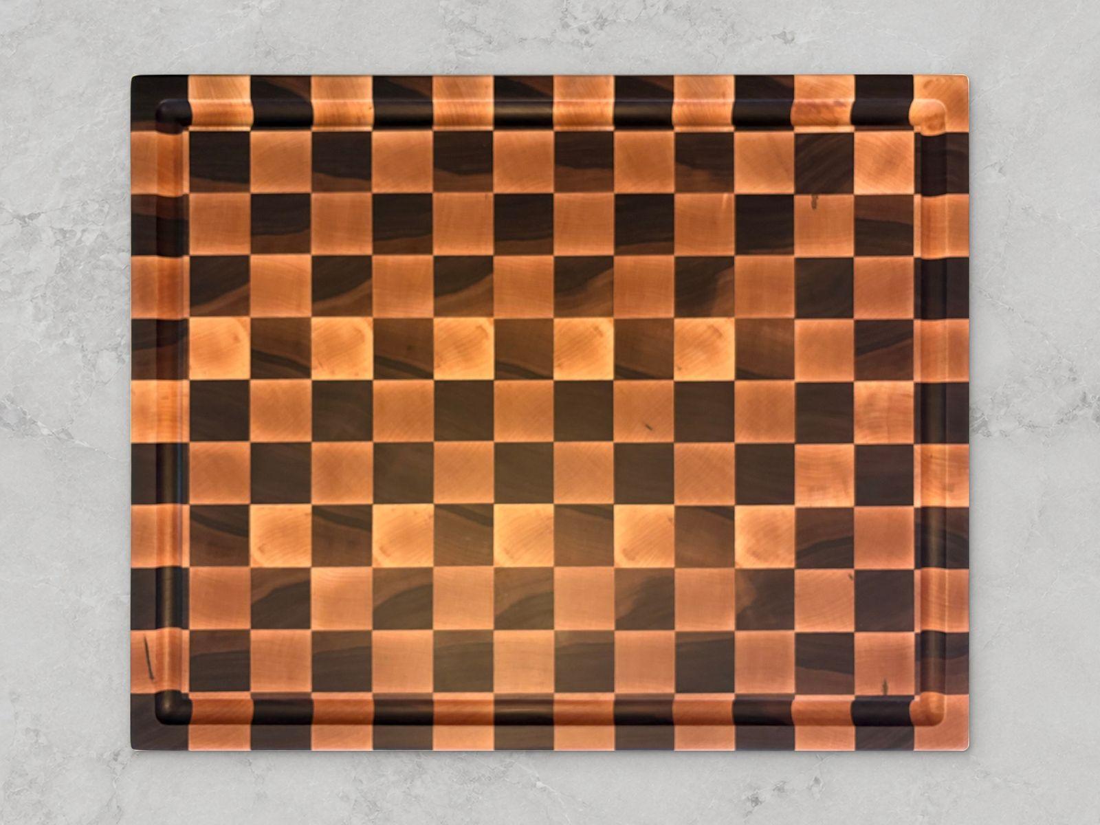 End-grain maple and walnut checkered board with a juice groove. 