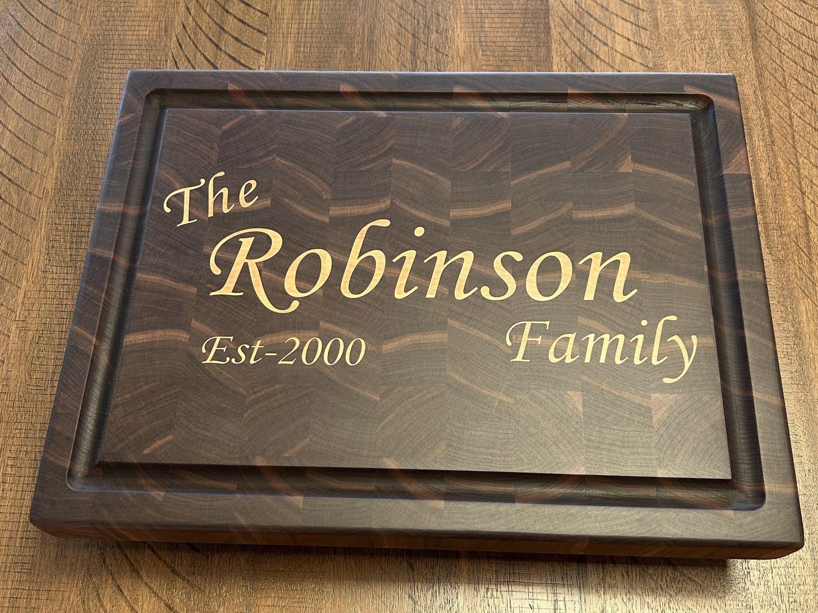 The Robinson Family personalized cutting board — walnut end grain with maple inlay